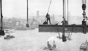 Men bolted the girders of the deck to the vertical stays of Manhattan Bridge