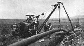 LOWERING A SECTION OF THE IRAQ PIPE LINE into its trench