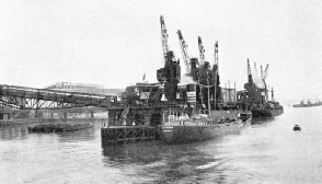 DISCHARGING COAL from colliers at the main Beckton pier