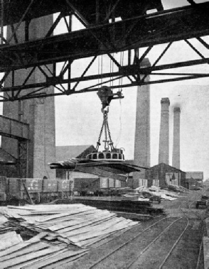 HANDLING TINPLATE with an electric lifting magnet suspended from the hook of an overhead travelling crane