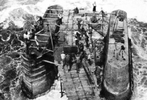 HEAVY SURF BREAKING OVER THE CORAL REEF at Nauru made the building of the massive concrete piers difficult