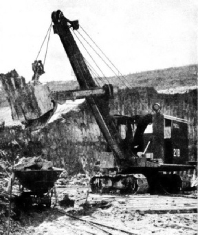 ELECTRIC EXCAVATOR at work in a Malayan open cast tin mine
