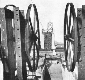 THESE LARGE WHEELS were mounted at the end of the suspension bridge to reel out the cables supporting the roadways