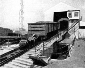 ON THE INCLINE leading up to the dumper the 120-tons coal trucks are pushed by a four-wheeled truck or bogie known as a mule