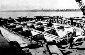 A CONCRETE CAISSON for the foundations of one of the main river piers of the Huey Long Bridge