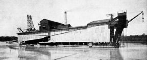 A LARGE TIN DREDGE used in a Malayan tinfield