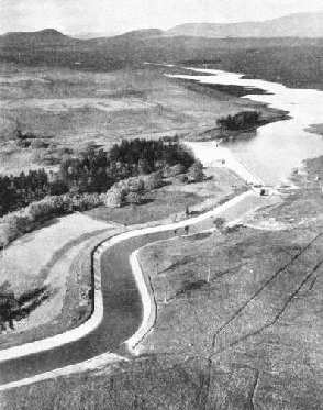 AN OPEN AQUEDUCT leads the water from the eastern end of the Ken dam to the reservoir formed by a dam across the Blackwater Burn