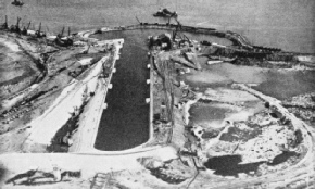 The reclaimed area was pumped dry and the huge King George V graving dock built