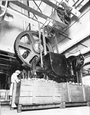 STAMPING OUT METAL PARTS — one of the large-scale processes used in a radio set factory