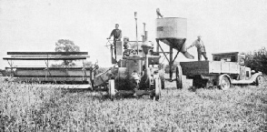 COMBINED HARVESTER AND THRESHER at work on a farm 