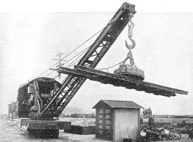 LIFTING A RAIL-CROSSING ASSEMBLY with a large circular electro-magnet 