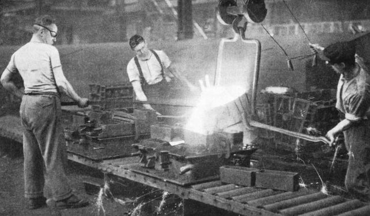 IN THE FOUNDRY at Coventry, motor car cylinder blocks and other engine units are cast