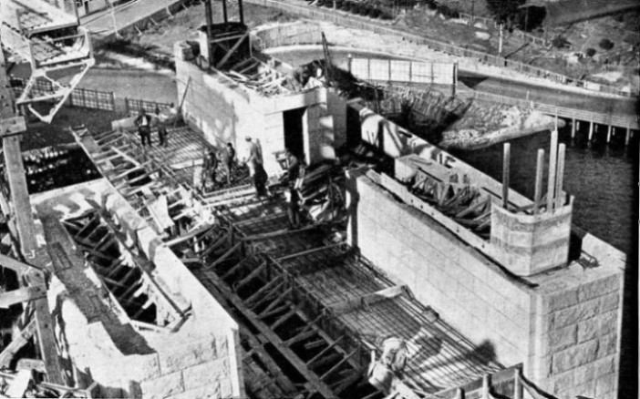 GRANITE-FACED CONCRETE PYLON of the Sydney Harbour bridge in course of construction at Milsons Point