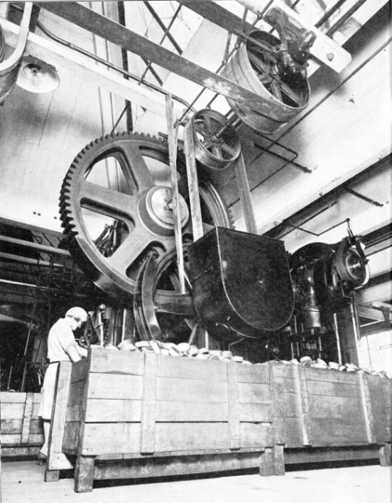 STAMPING OUT METAL PARTS — one of the large-scale processes used in a radio set factory
