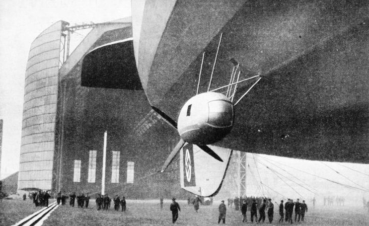 The airship Hindenburg leaving her enormous hangar