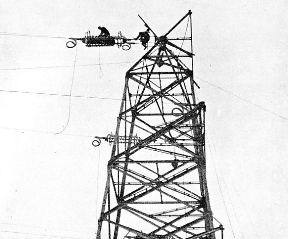 SOUTH ANCHOR TOWER with insulator strings being slung into position