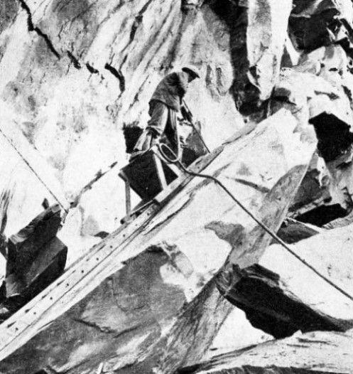 PNEUMATIC DRILL at work on the quarry face at Elterwater