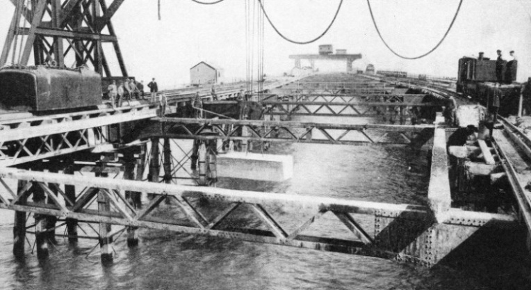 LOWERING A CONCRETE BLOCK to the bed of the sea in Dover Harbour