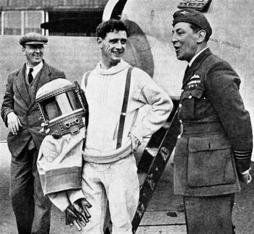FLIGHT-LIEUT. M. J. ADAM and the pressure suit which he wore on his record-breaking flights
