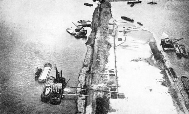 BACKING THE MAIN DAM with sand and facing it with stone. The North Sea is on the left and the former Zuider Zee is on the right