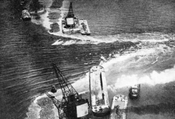 THE LAST GAP in the main dam which separates the North Sea from what was formerly the Zuider Zee