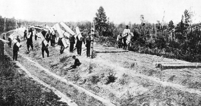 WORKERS CARRYING SLEEPERS for the new Trans-Siberian Railway